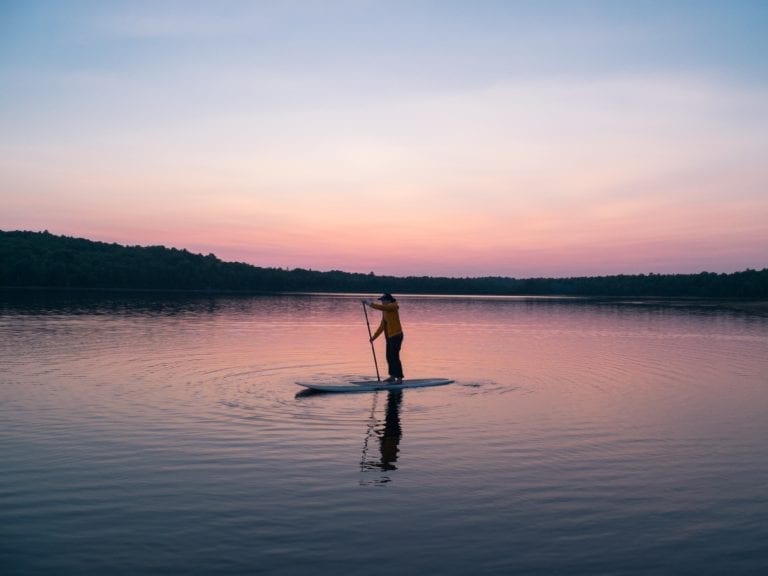 man riding board on middle of body of water 1790184 768x576